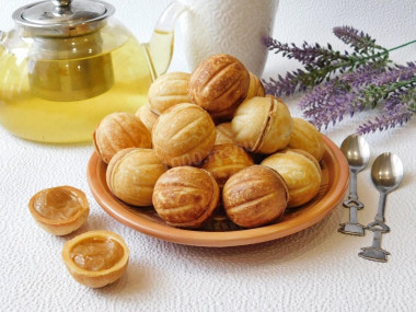 Nuts with boiled condensed milk in a hazelnut oven on gas