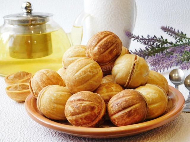 Nuts with boiled condensed milk in a hazelnut oven on gas