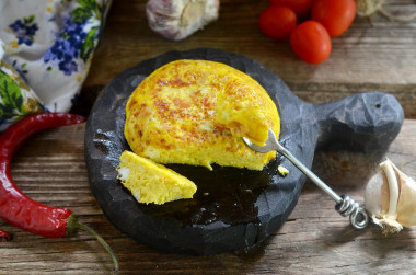 Fluffy omelet in a frying pan