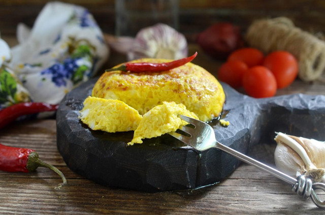 Fluffy omelet in a frying pan