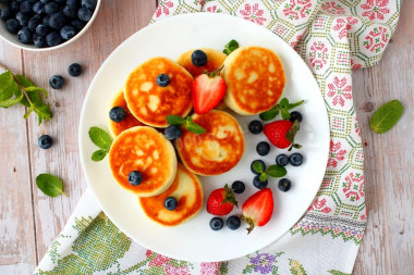 Cottage cheese pancakes with flour in a frying pan