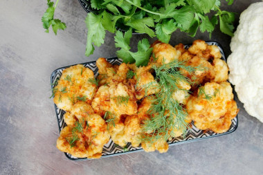 Cauliflower in batter in a frying pan