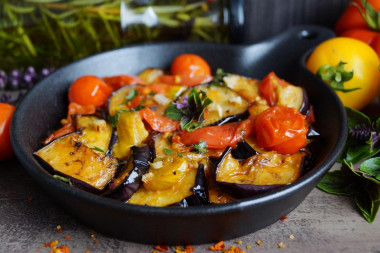 Eggplant in a frying pan with garlic and tomatoes quickly