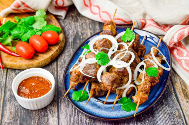 Barbecue on pork skewers in the oven