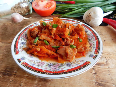 Pork meat with gravy in a frying pan