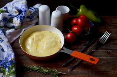 Eggs with cheese in a frying pan