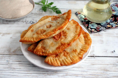 Chebureks in a pan with meat