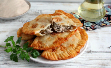 Chebureks in a pan with meat