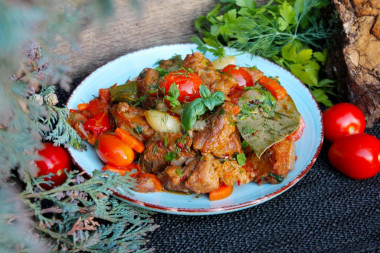 Pork meat in a cauldron over a fire