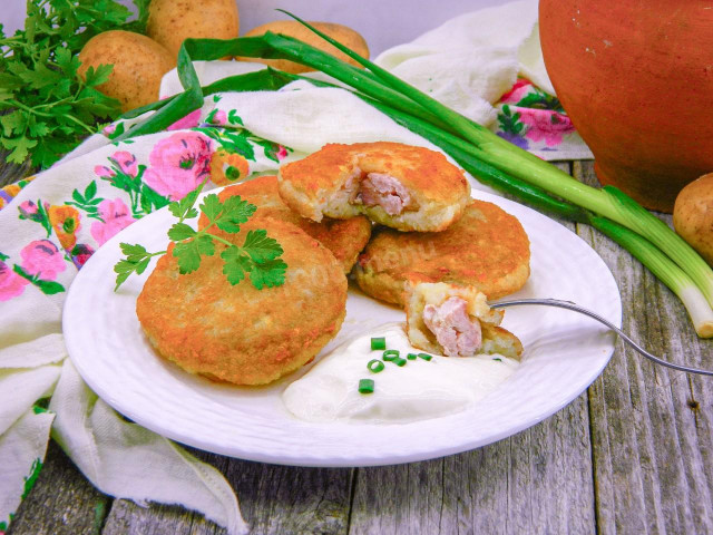 Potato pancakes with minced meat in a frying pan