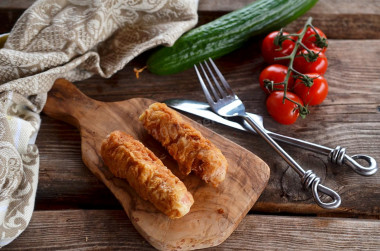 Sausages in batter in a frying pan