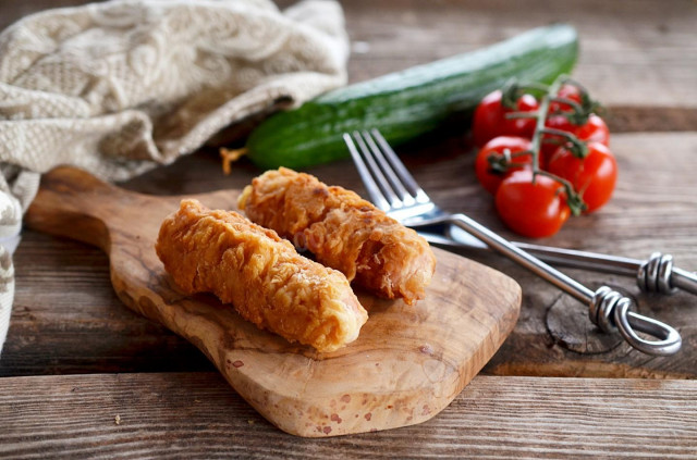 Sausages in batter in a frying pan