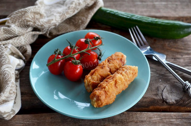 Sausages in batter in a frying pan