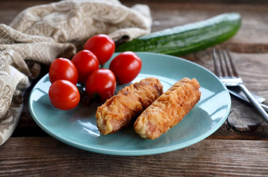 Sausages in batter in a frying pan