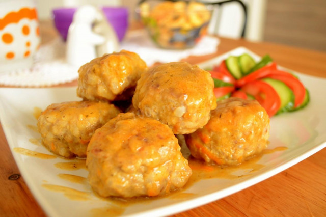 Meatballs in sour cream tomato sauce in a frying pan