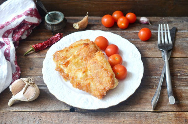 Fish in batter in a frying pan