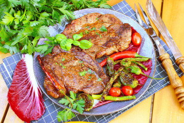 Beef steak on a grill on a grill on coals