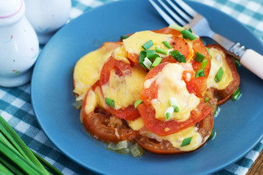 Tomatoes with cheese in a frying pan