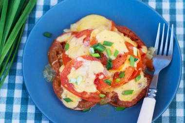 Tomatoes with cheese in a frying pan