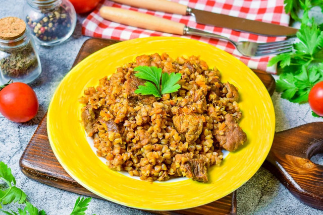 Merchant-style buckwheat with pork in a frying pan