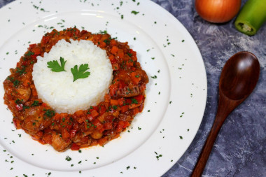 Milk with onions and carrots in a frying pan