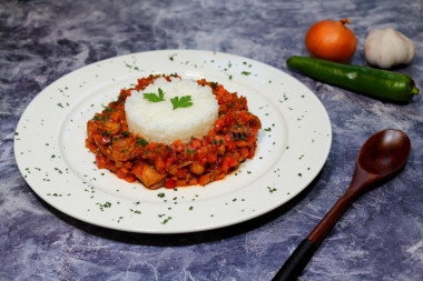 Milk with onions and carrots in a frying pan