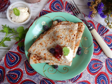 Pancakes on water with eggs thin with holes