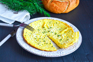 Omelet with cheese in a pan with milk is lush