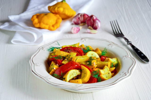 Zucchini with tomatoes and garlic in a frying pan